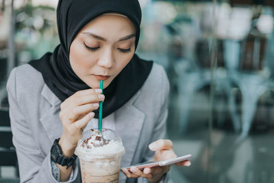 Midsection of woman holding ice cream