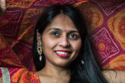 Close-up portrait of smiling young woman