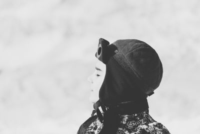 Boy on snow covered field during winter