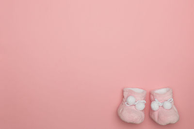Close-up of pink cake against colored background