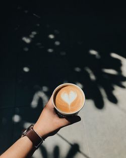 Hand holding coffee cup