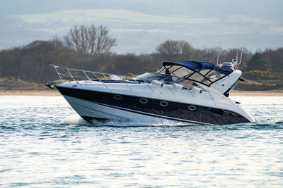 Speed boat at low tide heading out to sea