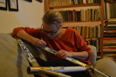 Woman writing on metal at home