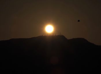 Low angle view of silhouette mountain against sky during sunset