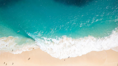 High angle view of waves rushing towards shore