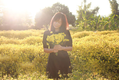 Young woman standing on field