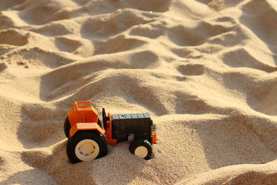 High angle view of toy on sand at beach