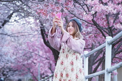 Young woman using a phone outdoors