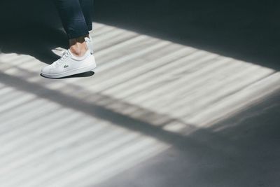 Low section of woman standing on tiled floor