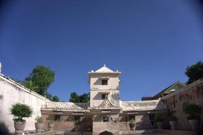 Low angle view of building against clear blue sky