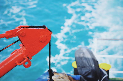 Close-up of crane on boat against sea