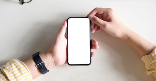 Midsection of man using mobile phone