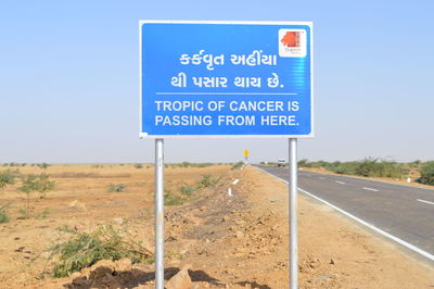 Road sign against blue sky