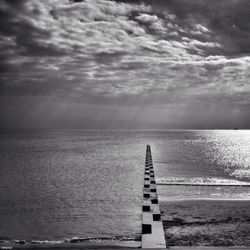 Scenic view of sea against cloudy sky