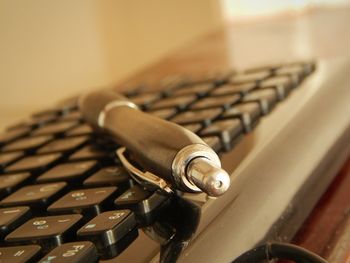 Close-up of pen on computer keyboard