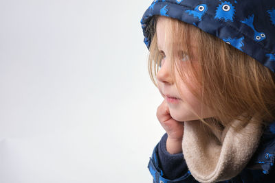 Close-up of young woman against white background