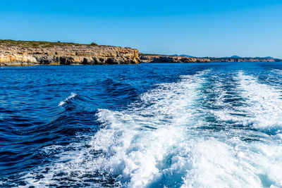 Scenic view of sea against clear blue sky