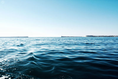 Scenic view of sea against clear blue sky