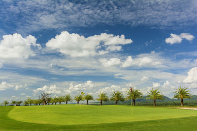 Scenic view of golf course against sky