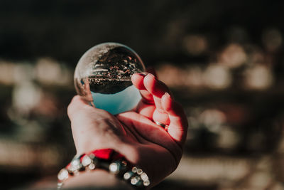 Close-up of hand holding crystal ball