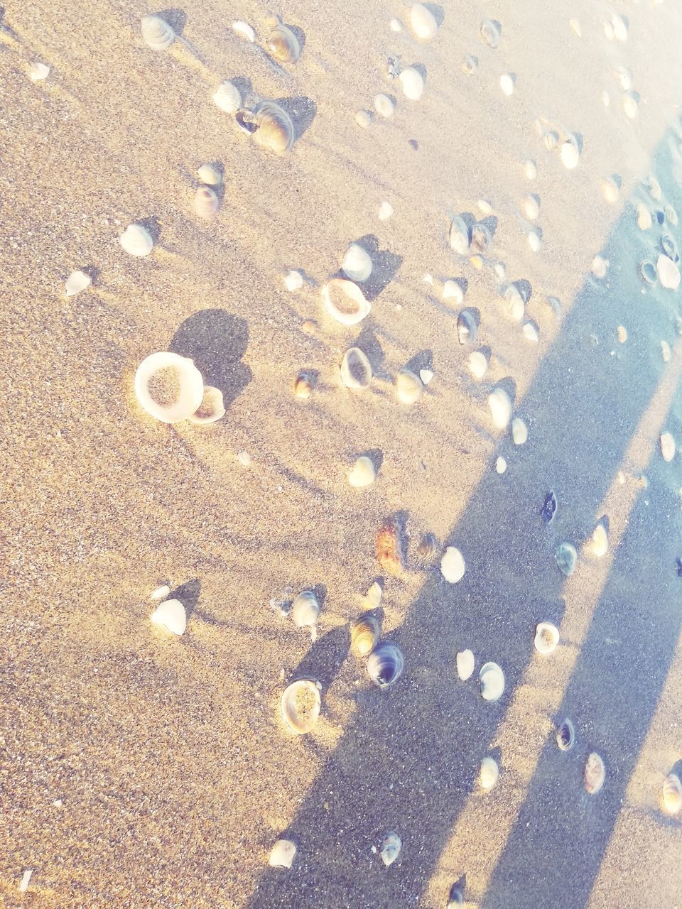 HIGH ANGLE VIEW OF SAND ON ROAD