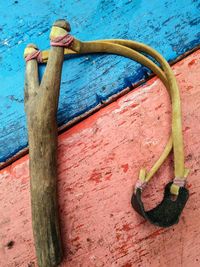 Close-up of rusty metal hanging against wall