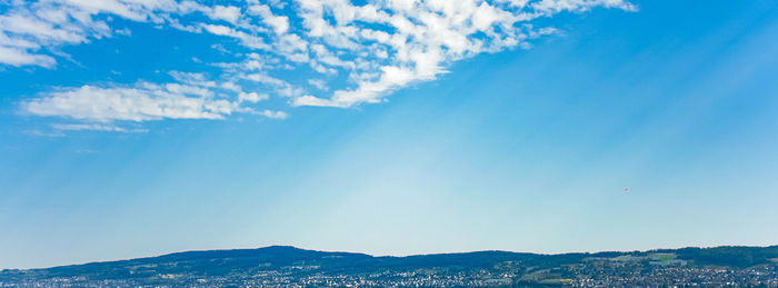 Low angle view of mountains against blue sky