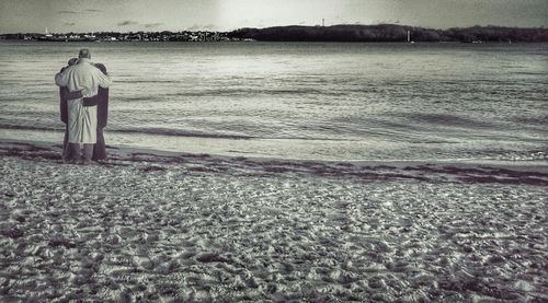 Rear view of man standing on beach