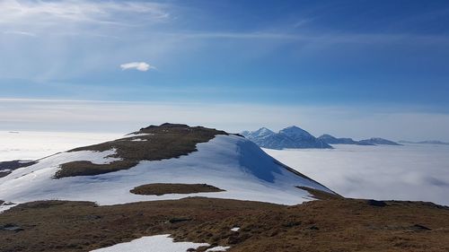 Scenic view of snowcapped mountain against blue sky