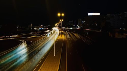 High angle view of light trails on highway at night