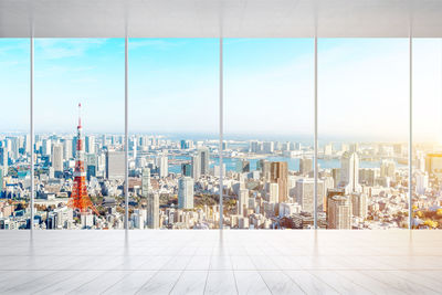 Cityscape against sky seen through glass window