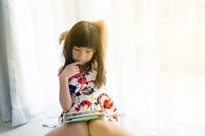Girl using digital tablet at home