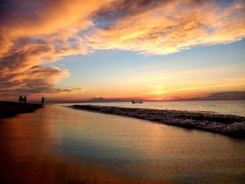 Scenic view of beach against sky during sunset