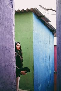 Woman standing against wall