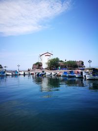 Boats in water against blue sky