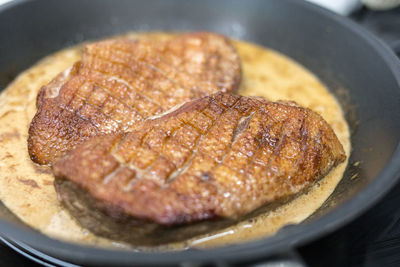 Close-up of meat in frying pan