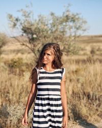 Young woman standing on field