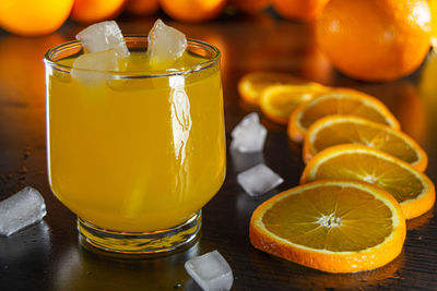 Orange juice with ice and orange slices. summer cocktail