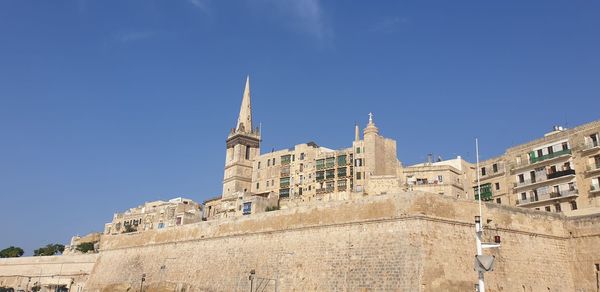 Low angle view of historical building against blue sky