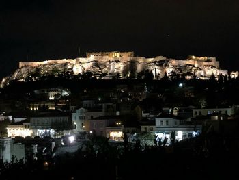 High angle view of illuminated buildings in city at night