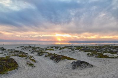 Scenic view of beach against sky during sunset