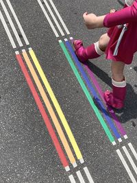 Low section of woman standing on road