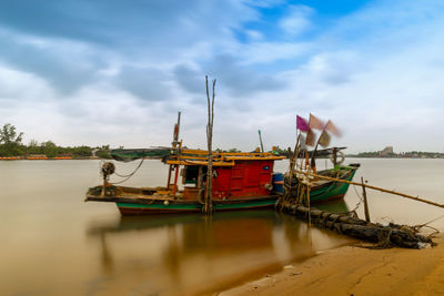 Boats moored at harbor