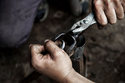 Close-up of mechanics working at workshop