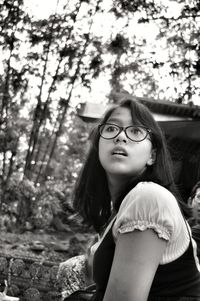 Portrait of young woman looking away in forest