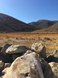 Rocks on landscape against clear sky