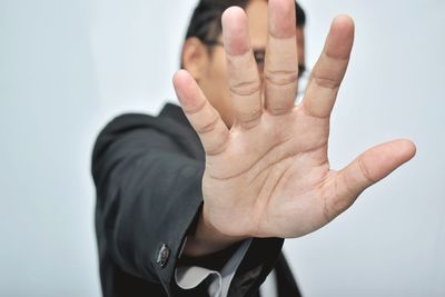 Close-up of human hand against white background