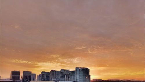 Low angle view of buildings against sky during sunset