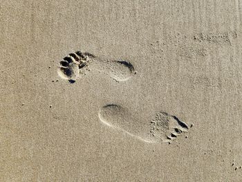 High angle view of footprints on sand