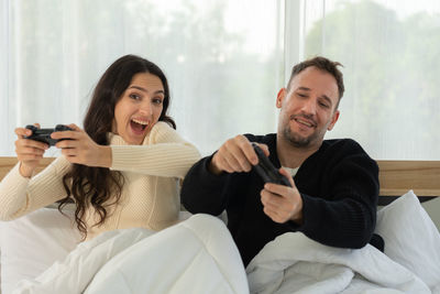 Young man and woman sitting at home